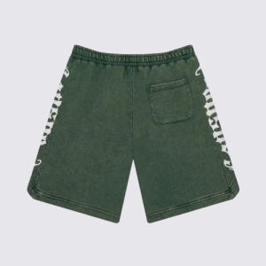 Green shorts with a drawstring waistband, featuring white geometric side patterns. The fabric appears casual and comfortable, conveying a relaxed vibe.